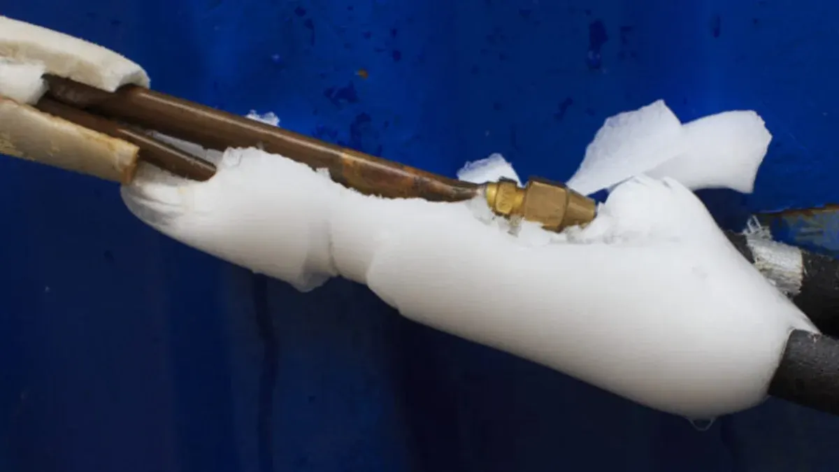 Heavy ice buildup around an air conditioner's refrigerant line